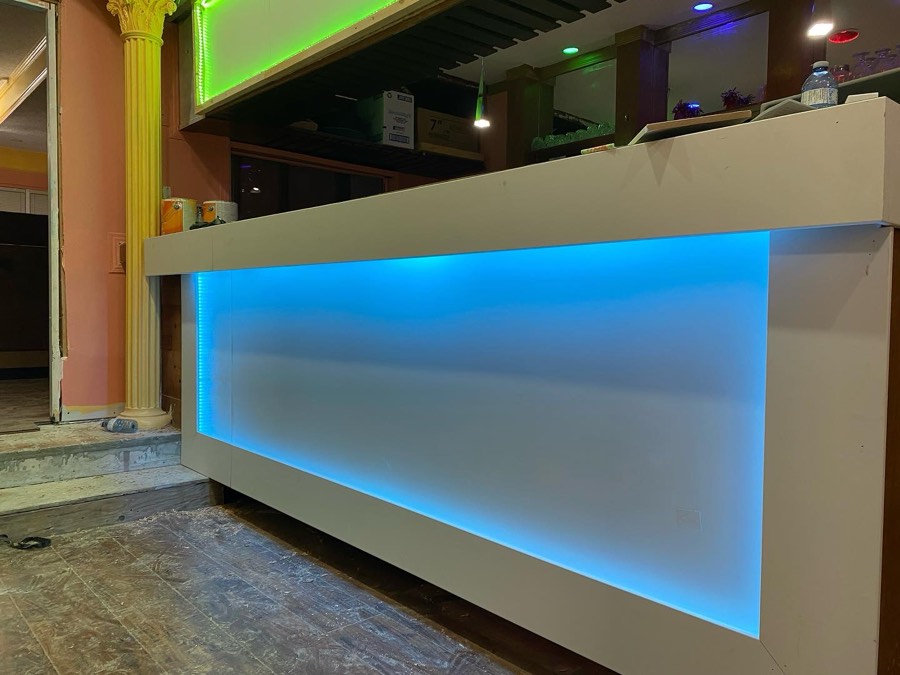 Commercial reception desk lit from within by blue LED