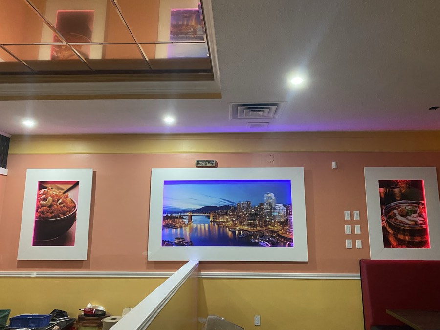 Restaurant interior with framed art and recessed ceiling lighting
