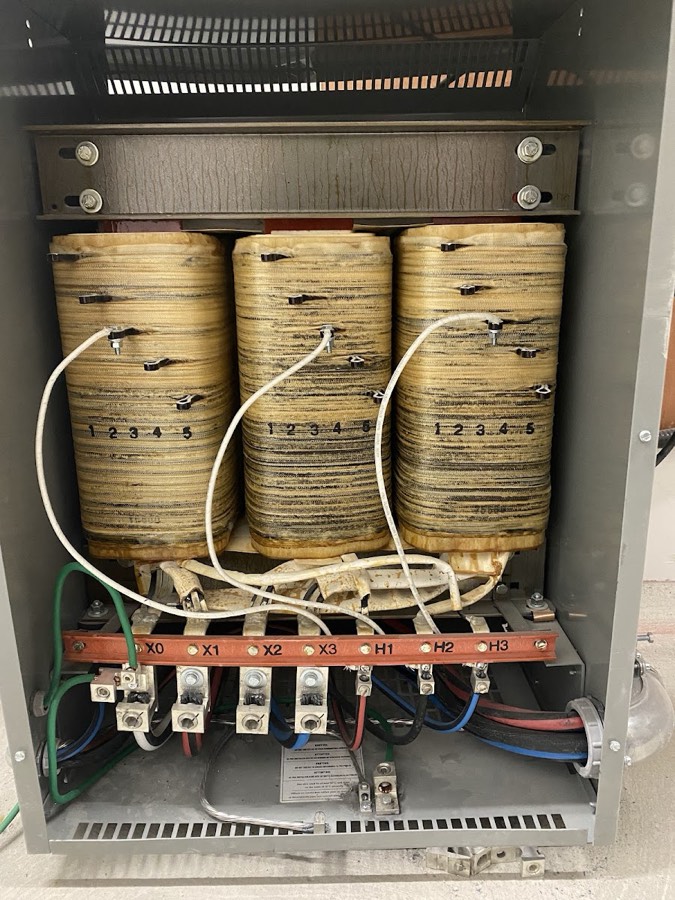 Three phase transformer wired inside its enclosure
